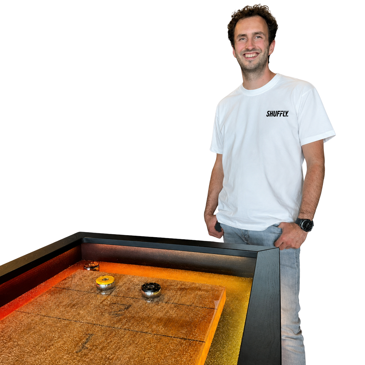 Smiling Shuffly team member in a white branded t-shirt standing beside a Shuffly shuffleboard table