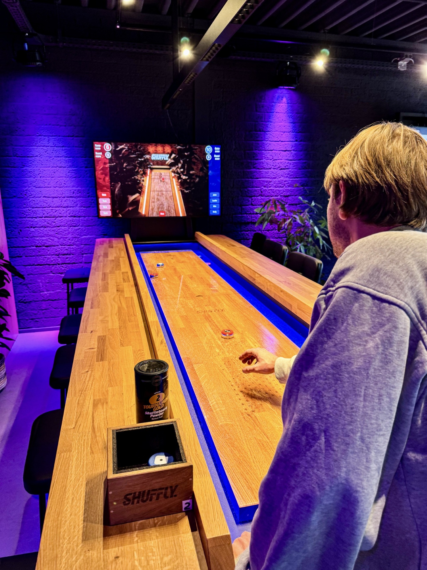 Guests playing an interactive shuffleboard